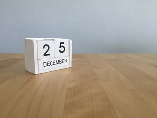 December 25th.December 25 white wooden calendar on vintage wood