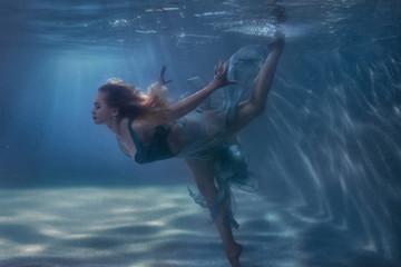 Woman dancing in the underwater.