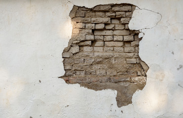 Crumbling Paintwork and Wall with Exposed Bricks