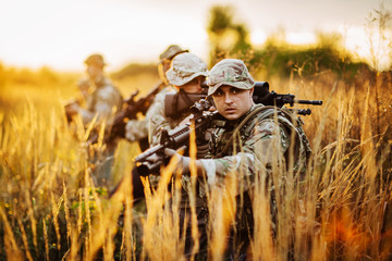 Rangers shooting with his weapon, rifle at sunset. War, army