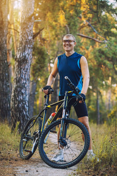 man cyclist rides forest paths