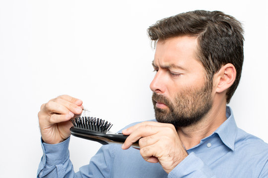 Man watching at hair brush