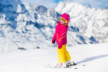 Little child skiing in the mountains