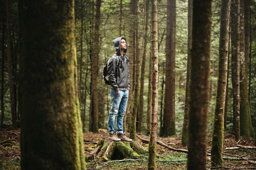 Obraz na płótnie Canvas Hooded man posing in the forest