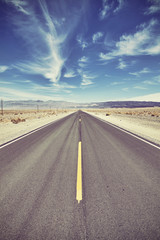 Vintage toned desert road in Death Valley, travel concept, USA.