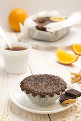 Still life with chocolate cupcake and cup of tea