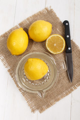squeeze of lemon juice in a glass lemon squeezer