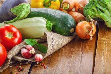 Fresh vegetables on a rustic wooden table. Organic ingredients for healthy food.
