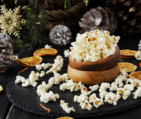 popcorn in a wooden plate on the background of Christmas