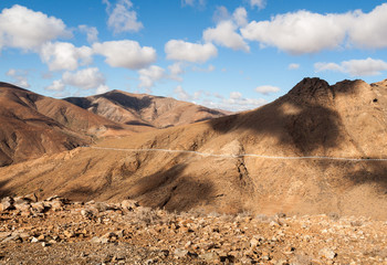 Beautiful volcanic mountains and the road on a mountain slope.  Road from la Pared to Betancuria . Fuerteventura. Canary Islands