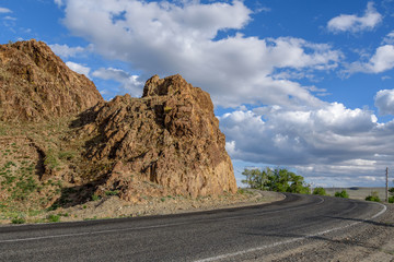 road mountains clouds curve asphalt red