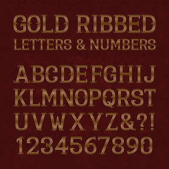 Golden ribbed letters and numbers with flourishes on red marble surface. Horizontal stripes vintage font. Isolated latin alphabet with figures.