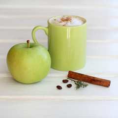 green Breakfast/ fresh apple with aromatic cinnamon stick, sprig of of juniper on the background of...
