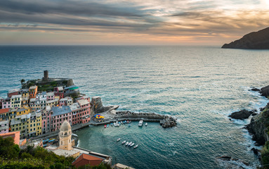 Vernazza village, Ocean Rugged Coast Harbour Aerial View Panorama Scenic Postcard view under Dramatic Sky Blur Cloud at Sunset in Summer. Cinque Terre National Park, Liguria Italy