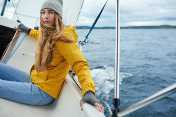 Young woman sailing the boat