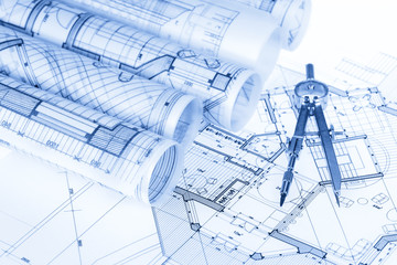 rolls of architecture blueprints, house plans &  compass