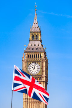 UK Flag and London Sight / Blurry Union Jack flag in front of London Big Ben clock tower and blue sky