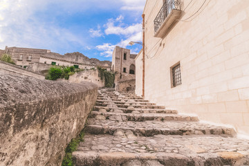 typical old stairs view of Matera under blue sky