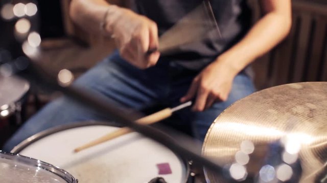 male musician playing drums and cymbals at concert