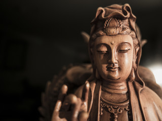 Fototapeta na wymiar Vintage style of Buddha statue with light dark background and focus face. buddha image used as amulets of Buddhism religion.