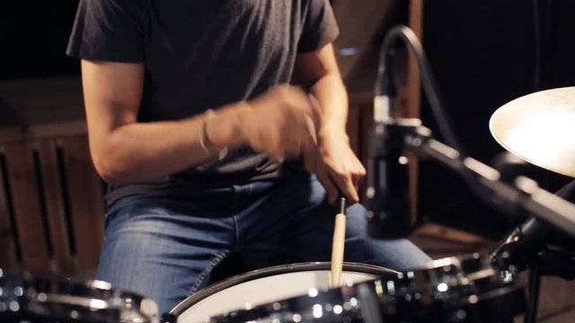 male musician playing drums and cymbals at concert