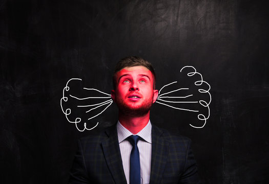 Portrait of thinking man on the background of the chalk board