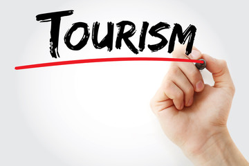 Hand writing Tourism with marker, concept background