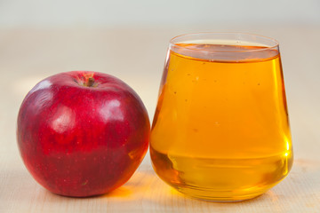 Delicious fresh squeezed apple juice in  transparent glass