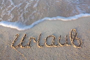 Holiday Written in sand at the beach.