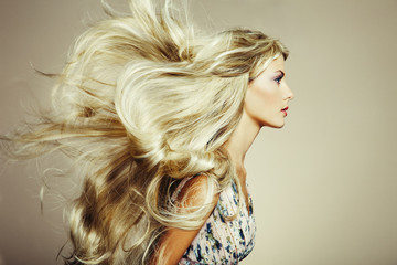 Photo of beautiful woman with magnificent hair. Blonde girl with long and shiny wavy hair ....