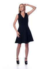 Young pretty long haired blonde woman posing in fashion dress on white background in a studio. Spring summer photo, catalog collection.