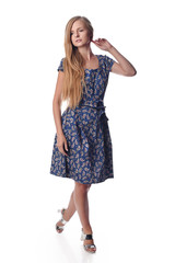 Young pretty long haired blonde woman posing in fashion dress on white background in a studio. Spring summer photo, catalog collection.