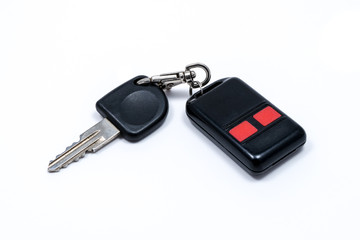 Old car key with car alarm remote control isolated on white background