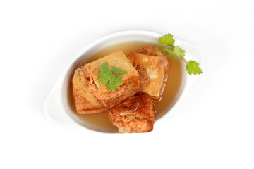 Gold bar soup as fried tofu wrap minced pork in soup and coriander . Top view.