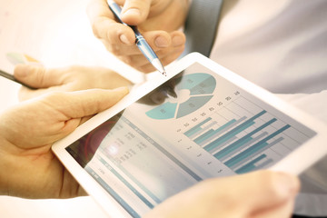 Business colleagues working and analyzing financial figures on a