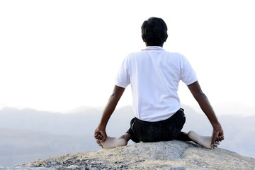 Indian Classic art Yoga performed in Mountain by Male Artist.