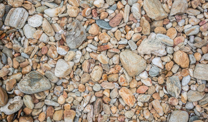 Small pebbles or sea stones on shore background , Thailand