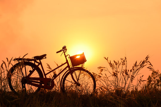 beautiful landscape image with Bicycle at sunset