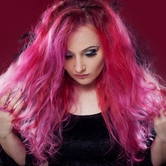 Fototapeta premium Attractive woman with pink hair in witch image. Halloween style