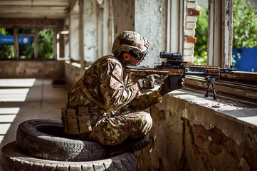 Man sniper with automatic rifle with a telescopic sight