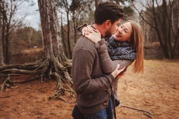 loving young couple happy together outdoor on cozy warm walk in autumn forest