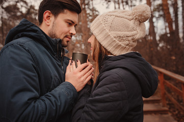 loving young couple happy together outdoor on cozy warm walk in autumn forest
