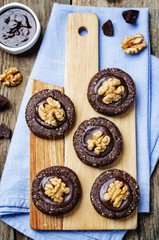 Fototapeta na wymiar Raw vegan chocolate dates hazelnut cookies with chocolate frosti