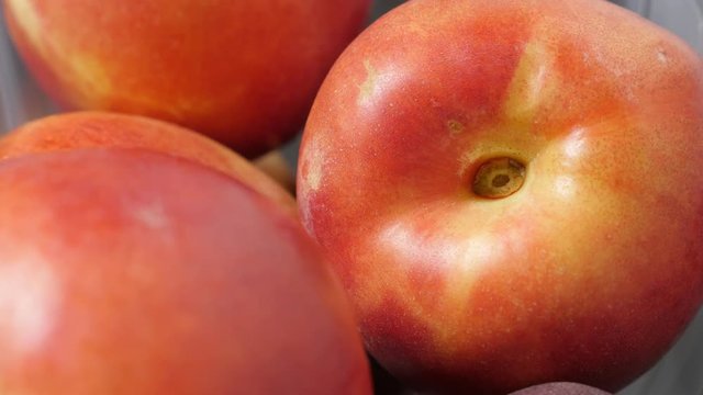 Box of nectarine peaches ready for sale tasty food background slow tilt 4K 2160p 30fps UltraHD footage - Prunus persica nucipersica colorful pieces healthy fruit 3840X2160 UHD tilting video 