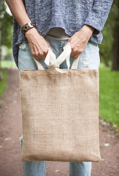 Woman Holding Empty Canvas Bag. Template Mock Up