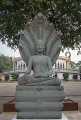  Buddha  with a  naga  are under the tree  in  temple named Wat  Whi We Garam, Tachalab,  Chanthaburi, Thailand.