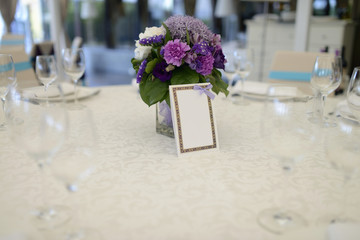 Beautiful wedding restaurant for marriage. White decor for bride and groom. Colorful decoration for celebration. Beauty bridal interior. Bouquet and flowers in hall