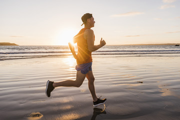 France, Crozon peninsula, jogger on the beach at sunset