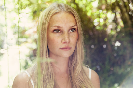 Portrait of young blond woman in the nature