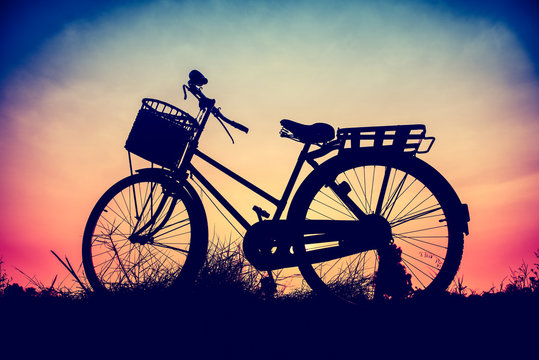 beautiful landscape image with Bicycle at sunset in vintage tone